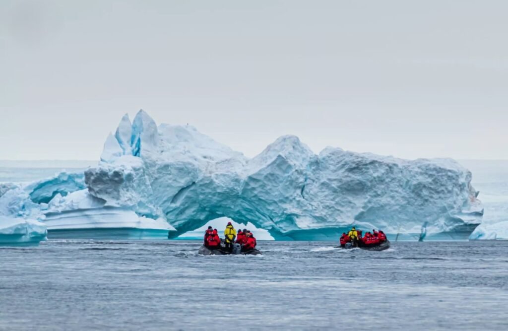 Luxury expedition cruise ship sailings & zodiac landing through Antarctica icebergs