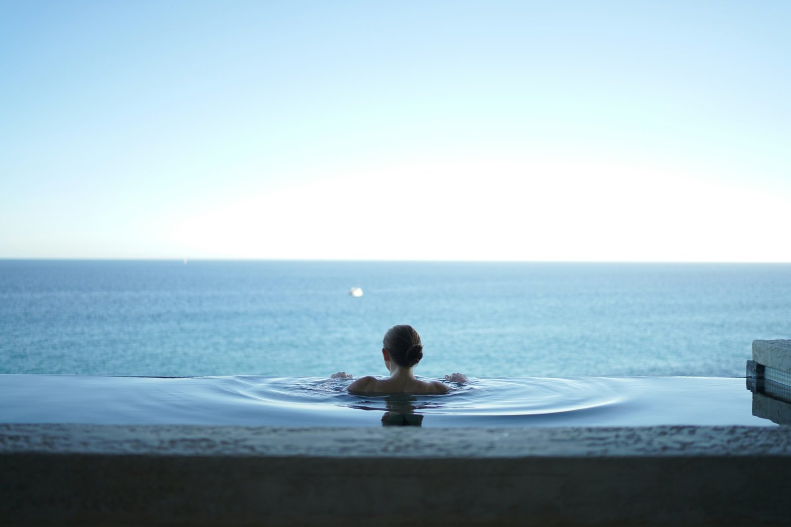 Luxury wellness retreat center with meditation gardens and quiet seating areas overlooking mountains